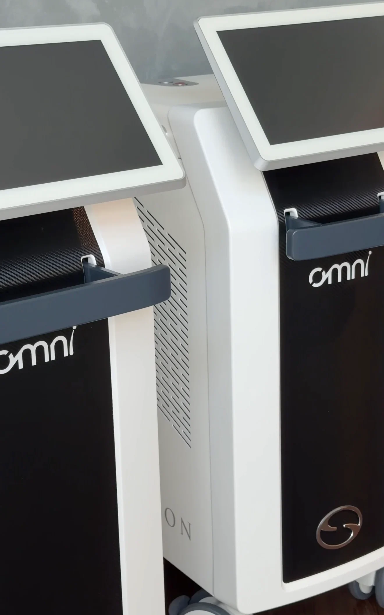 Two Omni laser body-contouring devices side by side in treatment room
