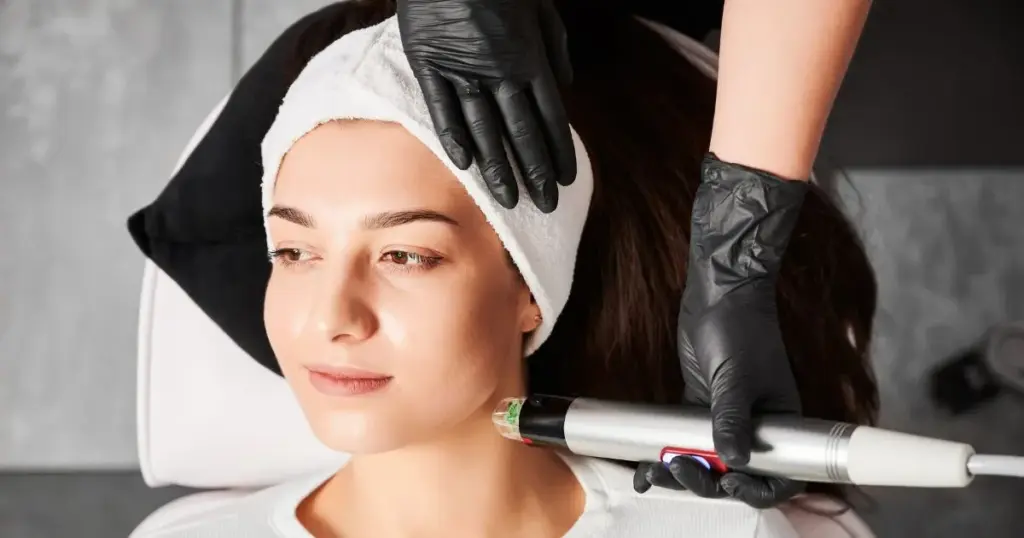 performing Radiofrequency Body Tightening on a client's thigh using the Lumenis Legend Pro device